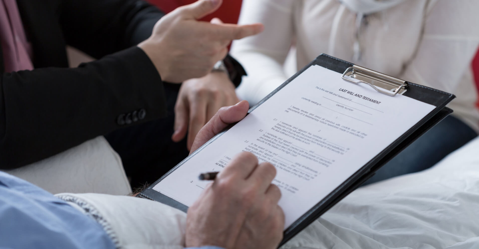 Close-up of older sick man holding his last will and testament